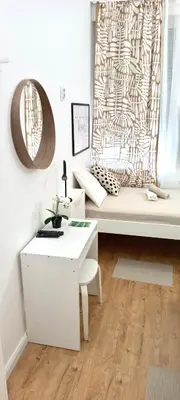 a living room with a white couch and a table at Rooms & Apartments Miavik in Belgrade