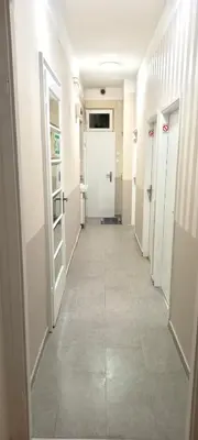 a corridor of a hallway with doors at Rooms & Apartments Miavik in Belgrade