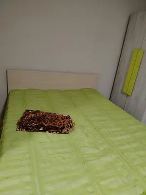 a bed with a leopard blanket on top of it at Garsonjera 35 kvm in Žarkovo