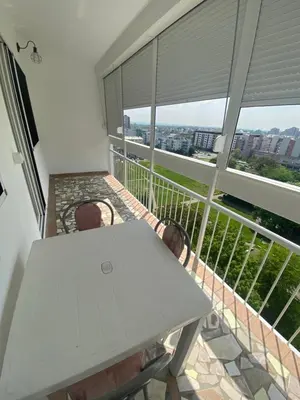 a table and chairs on a balcony with a view at Prestige in Belgrade