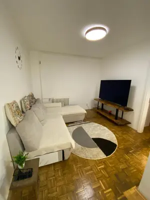 a living room with a couch and a flat screen tv at Prestige in Belgrade