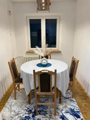 a dining room with a white table and chairs at Prestige in Belgrade