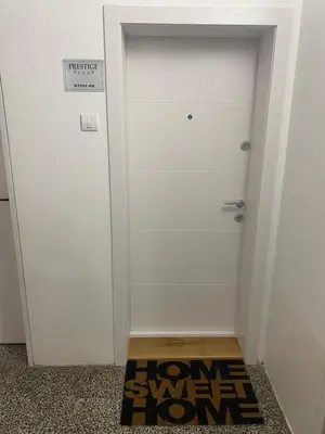 a door with a welcome mat in front of it at Prestige in Belgrade