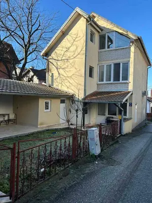 a house with a fence in front of it at Apartman Malena in Belgrade