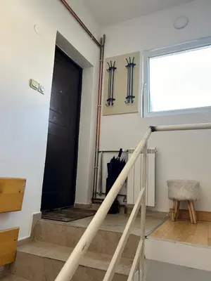 a stairway with a black door and a window at Apartman Malena in Belgrade