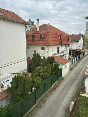 a city street with houses and a fence at Apartman Malena in Belgrade