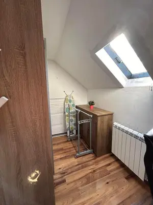 a room with a skylight and a desk in a attic at Apartman Malena in Belgrade