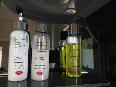 three bottles of liquids sitting on a table at Apartman LIMA in Belgrade