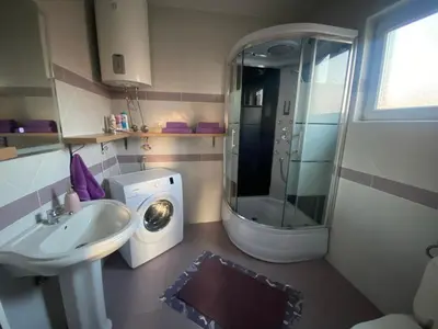 a bathroom with a washing machine and a sink at Apartman LIMA in Belgrade