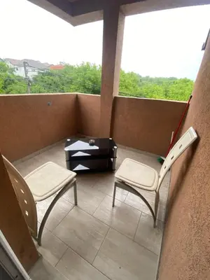 a balcony with two chairs and a table at Apartman LIMA in Belgrade