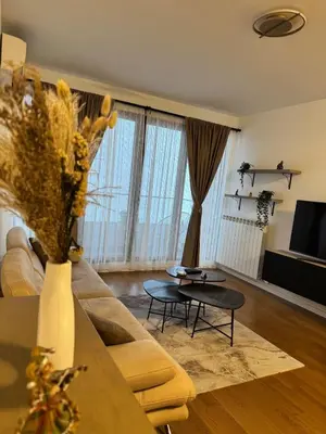 a living room with a couch and a table at Sunny Nest in Belgrade