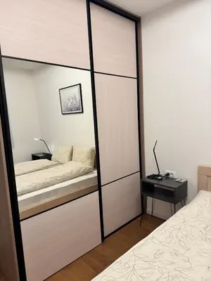 a bedroom with a sliding glass door with a bed at Sunny Nest in Belgrade