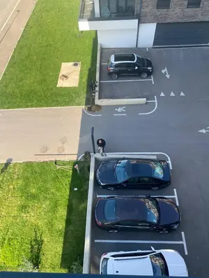 an aerial view of three cars parked in a parking lot at Sunny Nest in Belgrade
