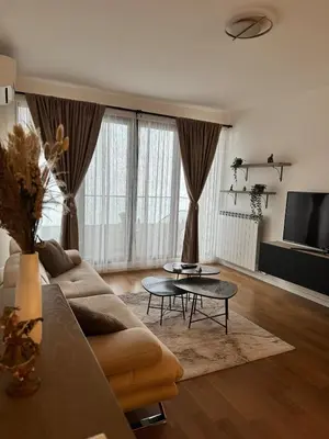 a living room with a couch and a table at Sunny Nest in Belgrade