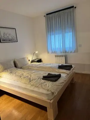 a bedroom with a bed with two towels on it at Sunny Nest in Belgrade