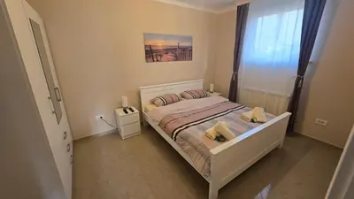 a bedroom with a bed with two pillows on it at Warm Nest in Belgrade