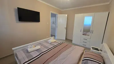a bedroom with a bed and a flat screen tv at Warm Nest in Belgrade