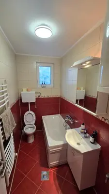 a bathroom with a toilet and a tub and a sink at Warm Nest in Belgrade