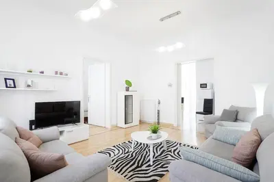 a living room with white furniture and a zebra rug at 155sqm 4BR Central Belgrade Apartment for 9 Guests in Belgrade