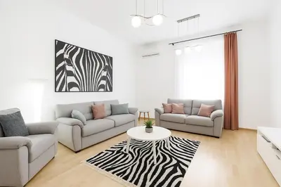 a living room with two couches and a table at 155sqm 4BR Central Belgrade Apartment for 9 Guests in Belgrade
