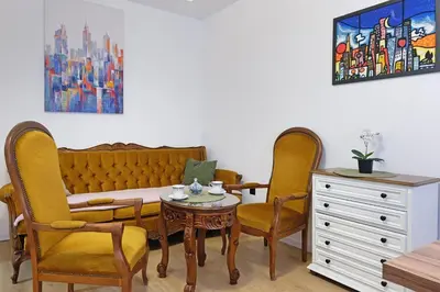 a room with a couch and two chairs and a table at Apartment Paradise Flora Centar in Belgrade