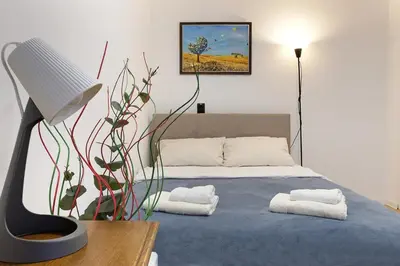 a bedroom with a bed with towels on it at Apartment Paradise Flora Centar in Belgrade
