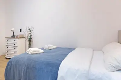a bedroom with a bed with two towels on it at Apartment Paradise Flora Centar in Belgrade