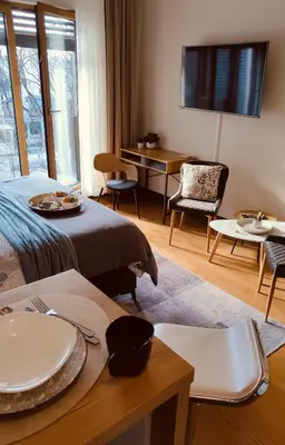 a hotel room with a bed and a table and chairs at Residence in Belgrade