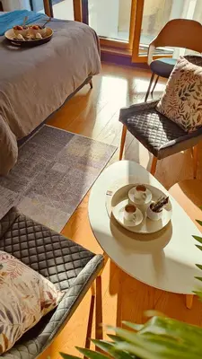a living room with a table and chairs and a bed at Residence in Belgrade