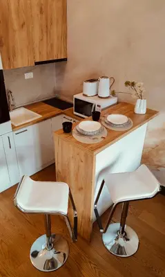 a kitchen with a table with two chairs and a microwave at Residence in Belgrade