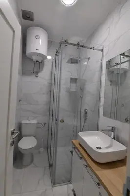 a bathroom with a shower and a toilet and a sink at Apartment Nikola in Belgrade