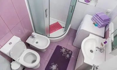 a pink bathroom with a toilet and a sink at Apartment Avala in Belgrade
