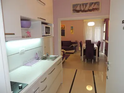 a kitchen with a sink and a table in a room at Apartment Avala in Belgrade