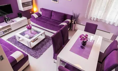 a purple living room with a purple couch and a table at Apartment Avala in Belgrade