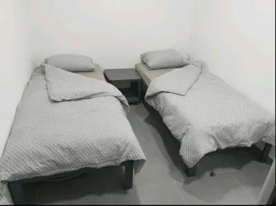two beds sitting next to each other in a room at New Belgrade Apartman - Near the Airport in Belgrade