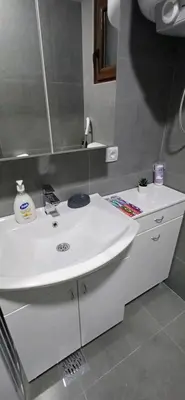 a bathroom with a white sink and a mirror at New Belgrade Apartman - Near the Airport in Belgrade