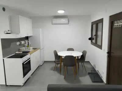 a kitchen with a table and chairs in a room at New Belgrade Apartman - Near the Airport in Belgrade