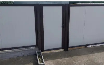 a row of four white doors on a building at New Belgrade Apartman - Near the Airport in Belgrade