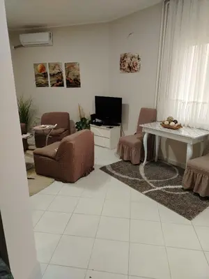 a living room with a couch and a table at STAN NA DAN - Garsonjera PRAMAC in Žarkovo