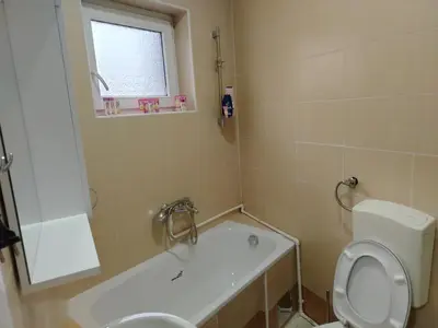 a bathroom with a toilet and a sink and a tub at STAN NA DAN - Garsonjera PRAMAC in Žarkovo