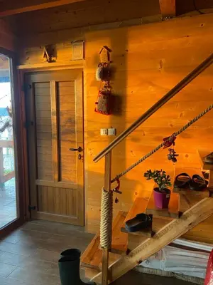 a wooden house with a staircase and a door at Bird of Paradise in Belgrade