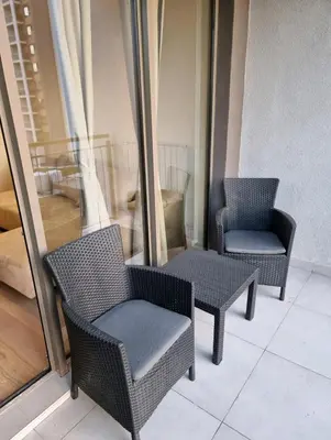 two chairs and a table on a balcony at Beograd Waterfront Verde in Belgrade