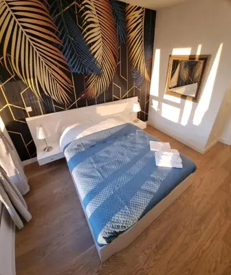 a bed in a room with a wall at Beograd Waterfront Verde in Belgrade