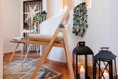a wooden easel in a room with two lights at Musical Shelter with Balcony 2min to Republic Square in Belgrade