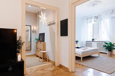 a living room with a bed and a mirror at Musical Shelter with Balcony 2min to Republic Square in Belgrade