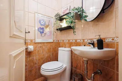 a bathroom with a toilet and a sink at Musical Shelter with Balcony 2min to Republic Square in Belgrade