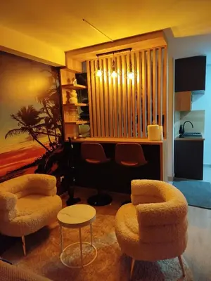 a living room with two chairs and a table at Diamond airport JACUZZI&SAUNA apartman Ledine in Ledine