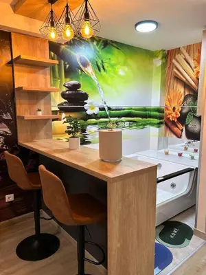 a kitchen with a large painting on the wall at Diamond airport JACUZZI&SAUNA apartman Ledine in Ledine