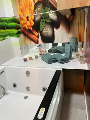 a bathroom with a white tub and a sink at Diamond airport JACUZZI&SAUNA apartman Ledine in Ledine