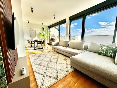 a living room with a couch and a table at Vracar-Luxury Penthouse in Belgrade